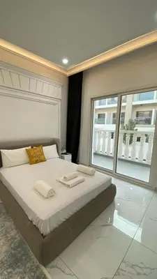 a bedroom with a large bed and a large window at Boutique Studio Elegant Stay in Arjan Dubai in Dubai