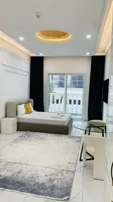 a bedroom with a bed and a large window at Boutique Studio Elegant Stay in Arjan Dubai in Dubai