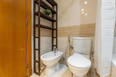 a bathroom with a toilet and a sink at GuestReady - 2BR l Stunning Marina Views in Dubai
