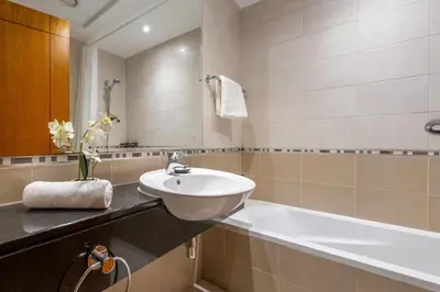 a bathroom with a sink and a bath tub at GuestReady - 2BR l Stunning Marina Views in Dubai