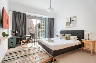 a bedroom with a bed and a large window at GuestReady - 2BR l Stunning Marina Views in Dubai