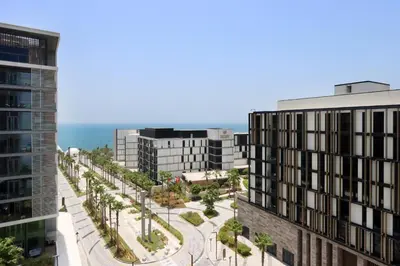 an aerial view of a city with buildings and the ocean at Livbnb- 3BR with Maid's Room with Full Ain Dubai View in Dubai