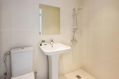 a bathroom with a sink and a toilet and a mirror at Livbnb- 3BR with Maid's Room with Full Ain Dubai View in Dubai