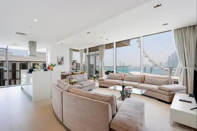 a living room with two couches and a table at Livbnb- 3BR with Maid's Room with Full Ain Dubai View in Dubai