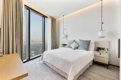 a bedroom with a large bed and a large window at Luxury 3 bedroom Apartment Full Sea & Ain Dubai View Address JBR in Dubai
