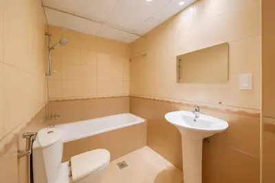 a bathroom with a sink and a toilet and a bath tub at Convenient Location in JVC Bright 1BR with Balcony in Dubai