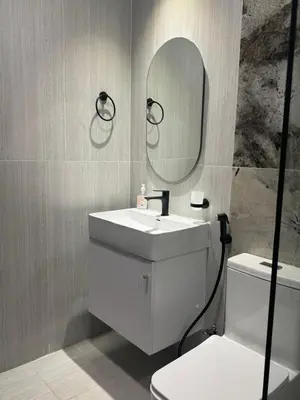 a bathroom with a sink and a mirror and a toilet at Luxury 2BR in Opal by Danube Private pool in Dubai