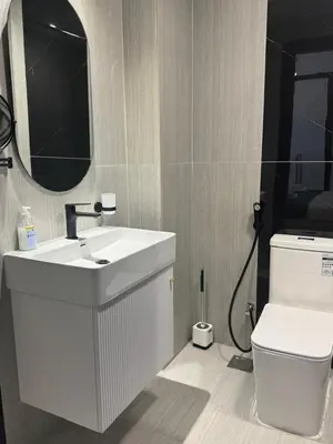 a bathroom with a white sink and a toilet at Luxury 2BR in Opal by Danube Private pool in Dubai