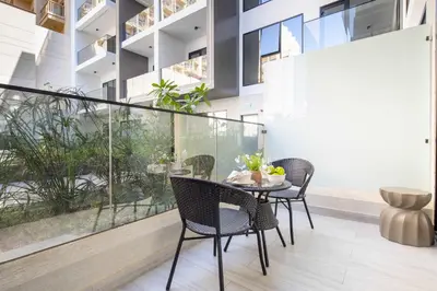 a dining room with a table and chairs on a balcony at Frank Porter - Al Serh Residences 11 in Dubai