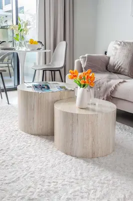 a living room with two wooden tables with flowers on it at Frank Porter - Al Serh Residences 11 in Dubai
