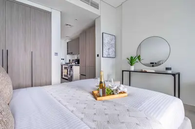 a bedroom with a large white bed with a mirror at Frank Porter - Al Serh Residences 11 in Dubai