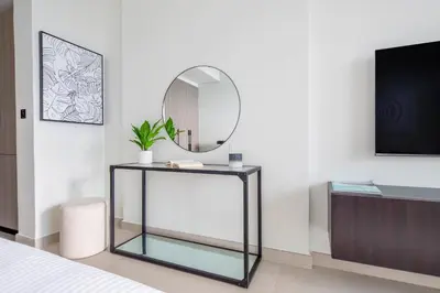 a mirror on a glass table in a bedroom at Frank Porter - Al Serh Residences 11 in Dubai