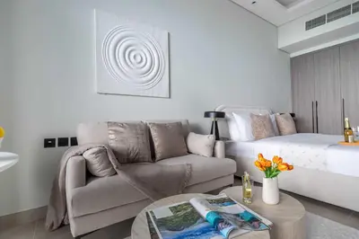 a living room with a couch and a bed at Frank Porter - Al Serh Residences 11 in Dubai