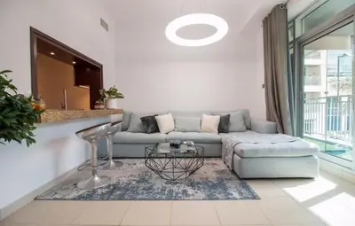 a living room with a couch and a table at Studio at Burj Views L246 in Dubai