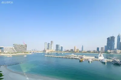 a harbor with boats in the water with a city at Lush Apartment - Private Beach Emaar - Beachfront in Dubai