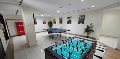 a billiard table in a room with a table at Peaceful Apartment - Cozy Interiors - 1BR in JVC in Dubai