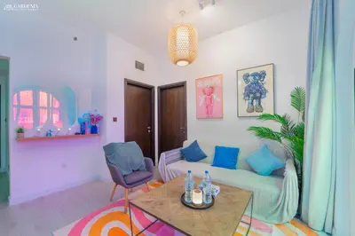 a living room with a couch and a table at Peaceful Apartment - Cozy Interiors - 1BR in JVC in Dubai