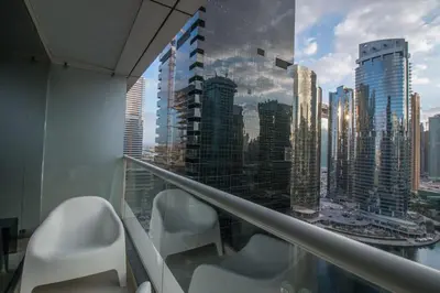 a balcony with chairs and a view of a city at Studio at Dubai Arch 2005 in Dubai