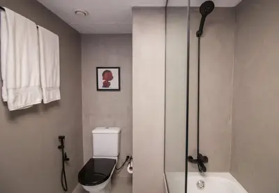 a bathroom with a shower and a toilet and a sink at Studio at Dubai Arch 2005 in Dubai