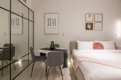 a bedroom with a bed and a table and chairs at Studio at Dubai Arch 2005 in Dubai