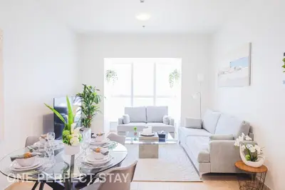 a living room with a couch and a table at 1BR Elite Residence4304 in Dubai
