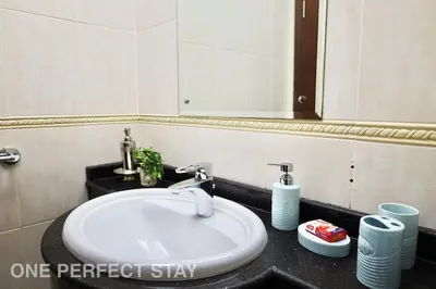 a bathroom with a white sink and a mirror at 1BR Elite Residence4304 in Dubai