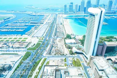 an aerial view of a city with a tall building at 1BR Elite Residence4304 in Dubai