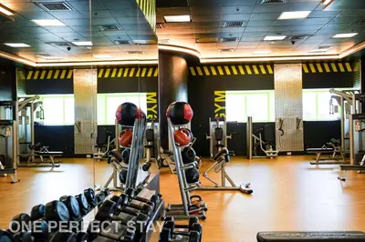 a gym with treadmills and weights in a room at 1BR Elite Residence4304 in Dubai