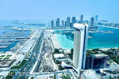 an aerial view of a city with a tall building at 1BR Elite Residence4304 in Dubai