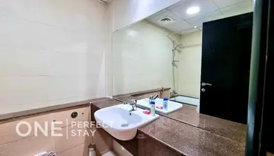 a bathroom with a sink and a mirror at 1BR Diamond Views 403A in Dubai