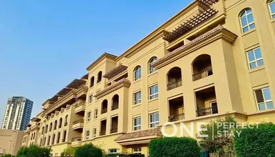 a large yellow building with windows on the side of it at 1BR Diamond Views 403A in Dubai