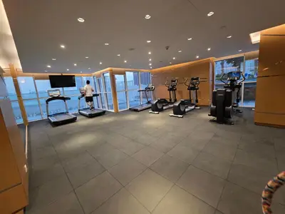 a gym with treadmills and ellipticals in a building at Dragon Golden Apartment 003 in Dubai