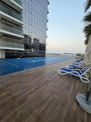 a row of lounge chairs sitting on the deck of a building at Dragon Golden Apartment 003 in Dubai