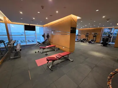 a gym with exercise equipment in a building at Dragon Golden Apartment 003 in Dubai