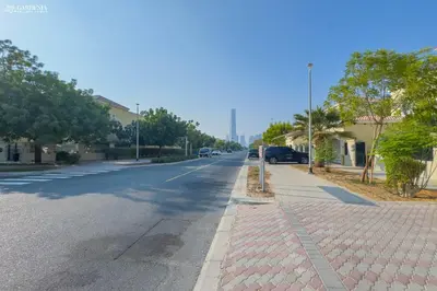 an empty street with cars parked on the side of the road at Elite Villa in Jumeirah Park - Private Pool - 4BR in Dubai