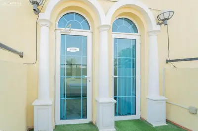 a door in a building with two windows at Elite Villa in Jumeirah Park - Private Pool - 4BR in Dubai