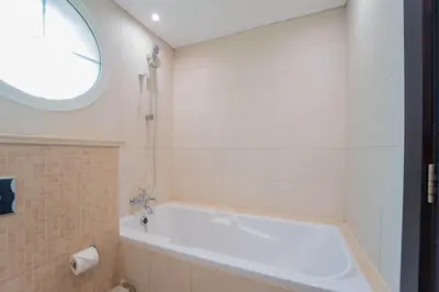 a white bath tub in a bathroom with a window at Elite Villa in Jumeirah Park - Private Pool - 4BR in Dubai