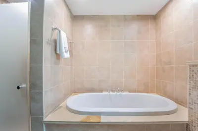 a bathroom with a bath tub and a shower at Elite Villa in Jumeirah Park - Private Pool - 4BR in Dubai