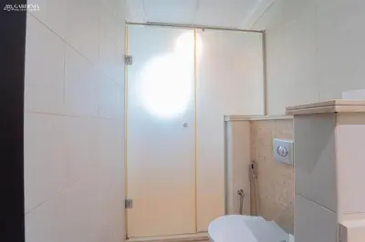 a white bathroom with a toilet and a shower at Elite Villa in Jumeirah Park - Private Pool - 4BR in Dubai