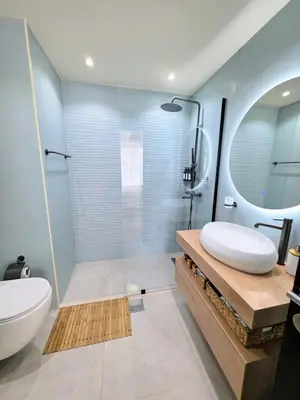 a bathroom with a shower and a sink and a toilet at Chic waterfront 1 bedroom apartment, walk to beach, promenade, metro in Dubai