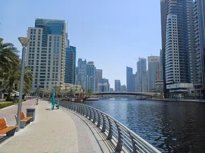 a river in a city with tall buildings at Chic waterfront 1 bedroom apartment, walk to beach, promenade, metro in Dubai