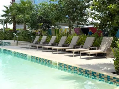 a row of lounge chairs next to a swimming pool at GuestReady - 2BR l City Chic in the Sky in Dubai