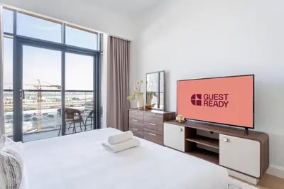 a bedroom with a tv on a white wall at GuestReady - Lux Apt Downtown | Near Dubai Mall in Dubai