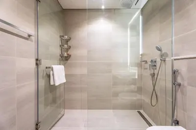 a bathroom with a shower with a glass door at GuestReady - Lux Apt Downtown | Near Dubai Mall in Dubai