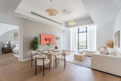 a living room with a table and chairs and a couch at GuestReady - Lux Apt Downtown | Near Dubai Mall in Dubai