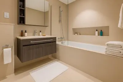 a bathroom with a shower and a tub and a sink at Downtown with Direct Access Dubai Mall & Burj Khalifa in Dubai