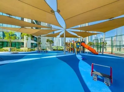 a swimming pool with a playground with a slide at Downtown with Direct Access Dubai Mall & Burj Khalifa in Dubai