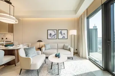 a living room with a couch and a table at Maison dOpera by NAMUVE - Boulevard Views in Dubai