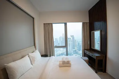 a hotel room with a bed with two towels on it at Maison dOpera by NAMUVE - Boulevard Views in Dubai