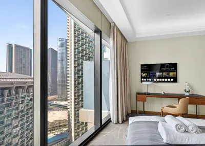 a bedroom with a view of a city at Address Residences Dubai Opera - Boulevard Views 1 & 2 Bedroom Apartment 5 minute walk to Burj Khalifa & Dubai Mall by NAMUVE in Dubai